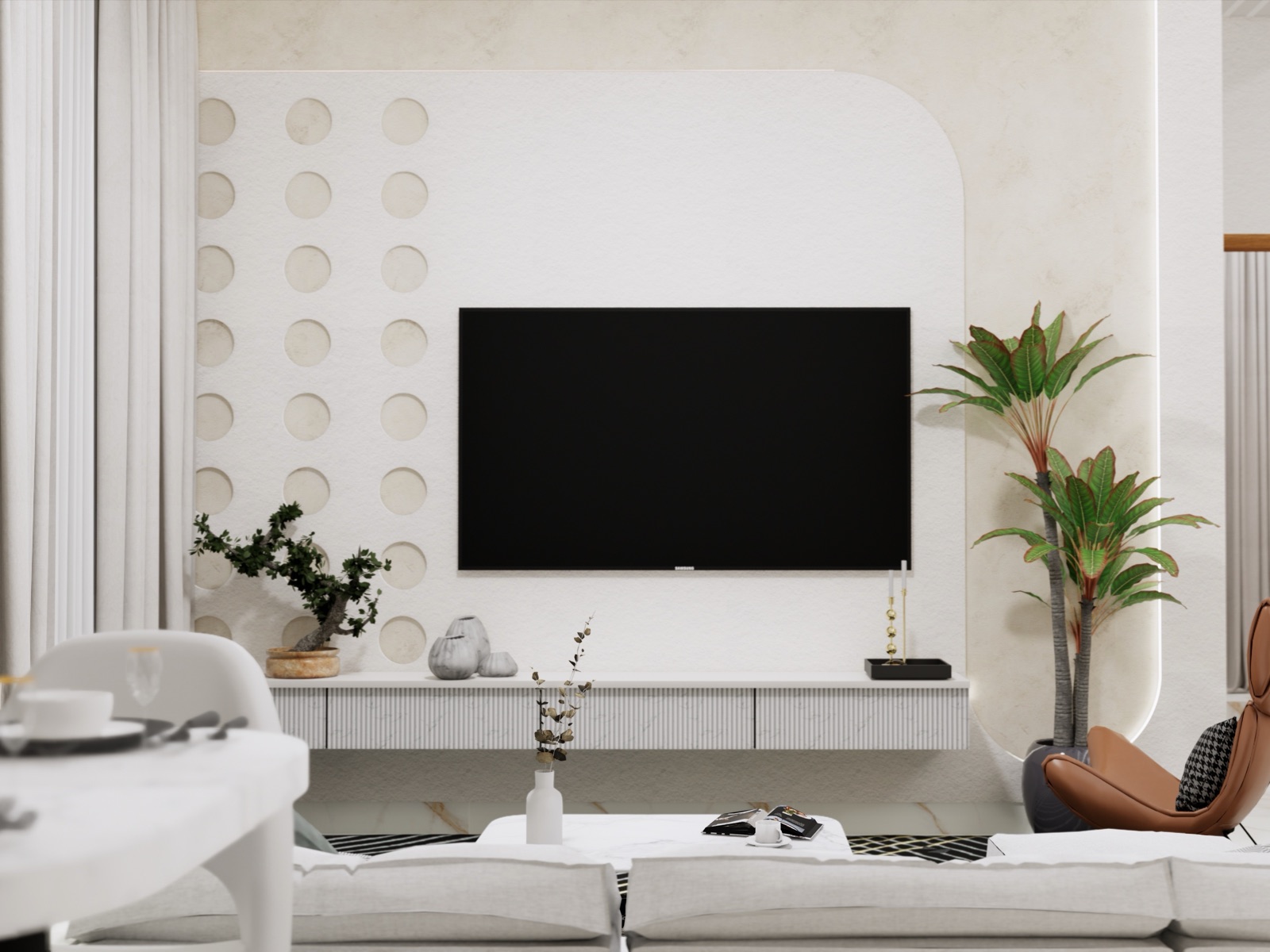 White TV wall with a wall-mounted TV above a long white floating console with ribbed drawer fronts, a panel of circular recesses to the left, a rounded edge with hidden lighting, plants and a white sofa in front