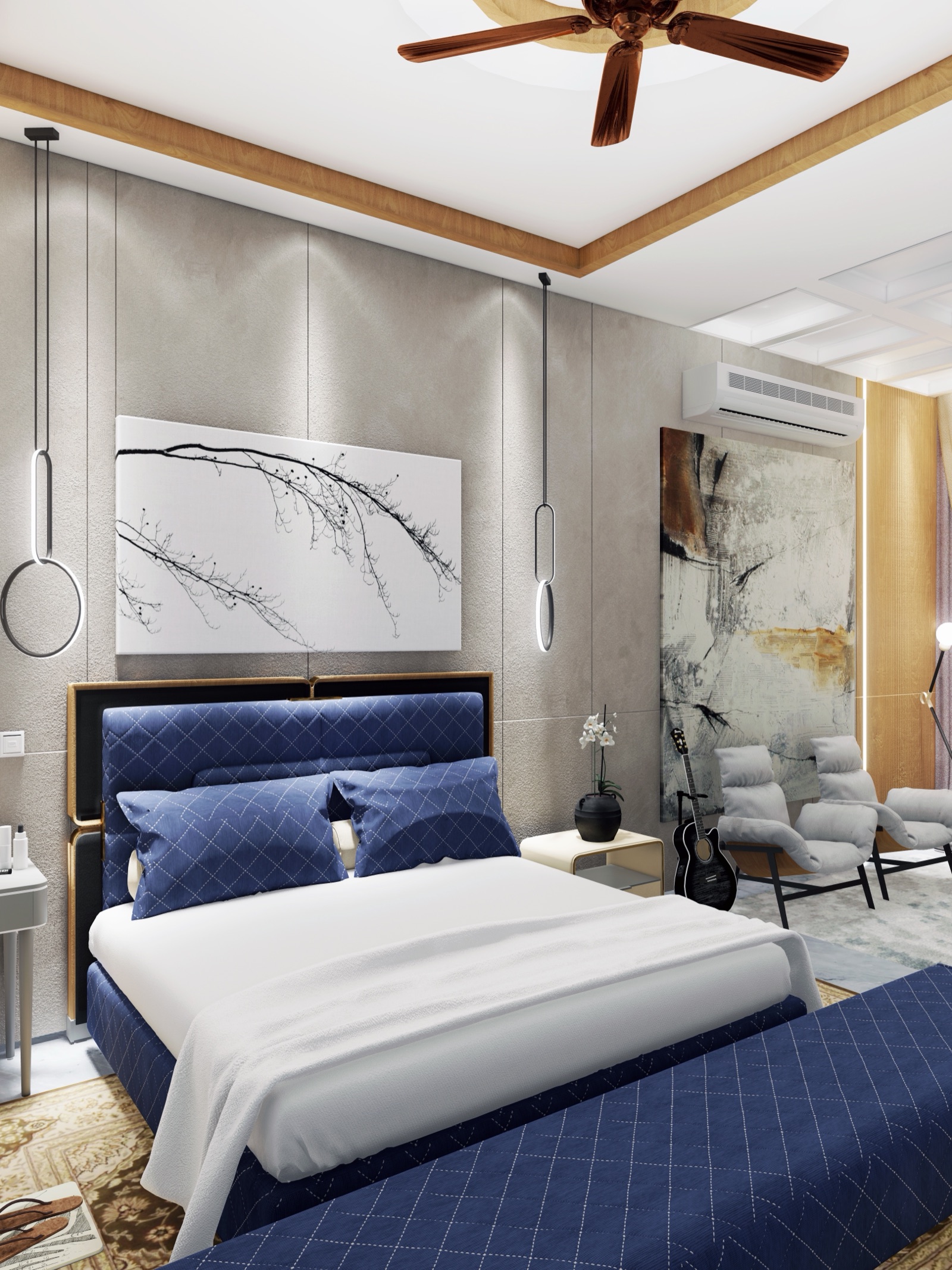 Design render of a bedroom in a Pune home: a navy quilted upholstered bed with a matching bench, a grey panelled wall behind it with a framed branch artwork and two ring pendant lights, a false ceiling with a wood-finish border and a ceiling fan, and two grey lounge chairs by a large abstract canvas