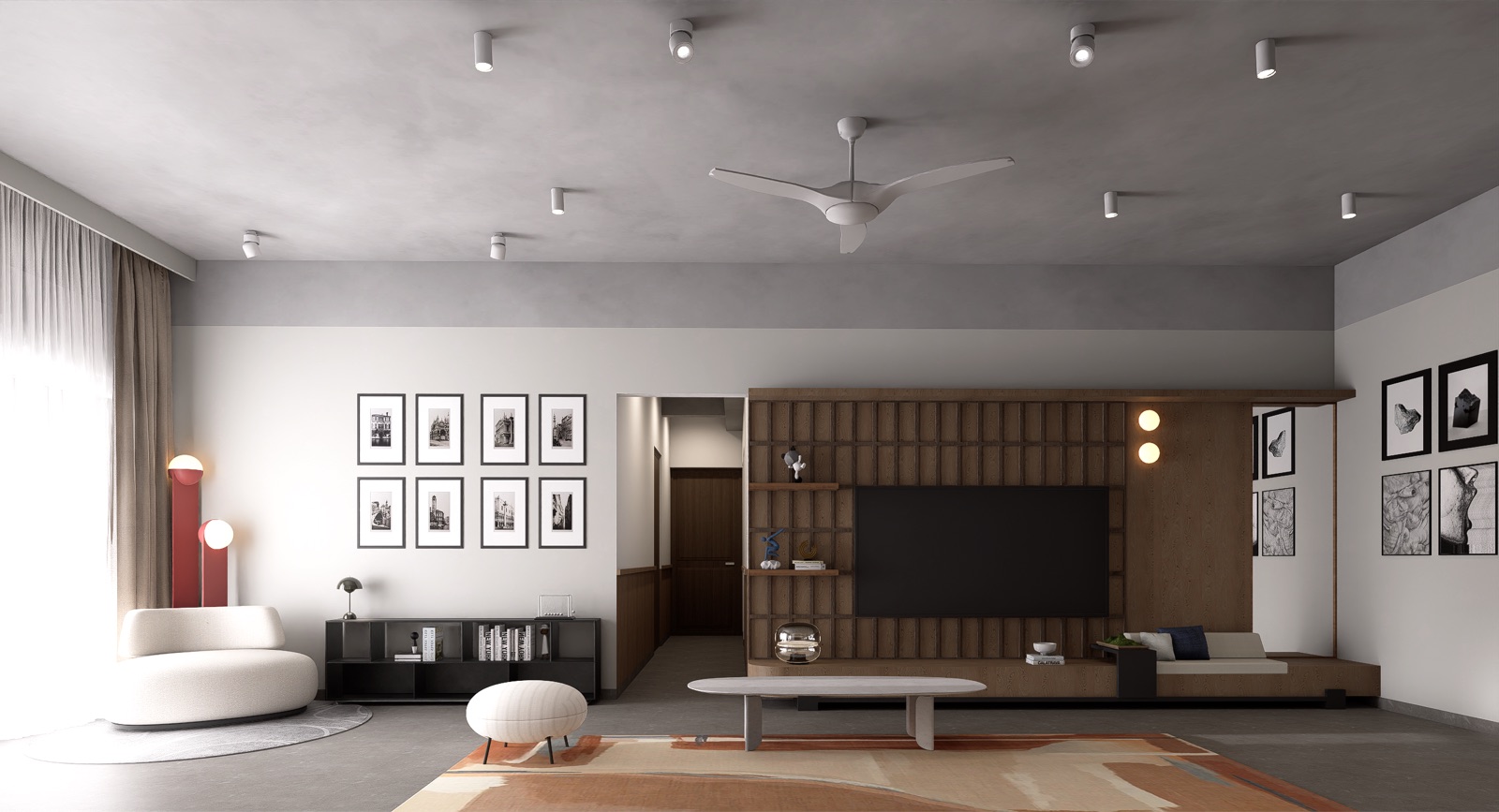 Wide living room with the TV set into a slatted timber wall that runs into a built-in bench and open shelves, a rounded white lounge chair, a pouf, framed prints, two red floor lamps and ceiling spotlights