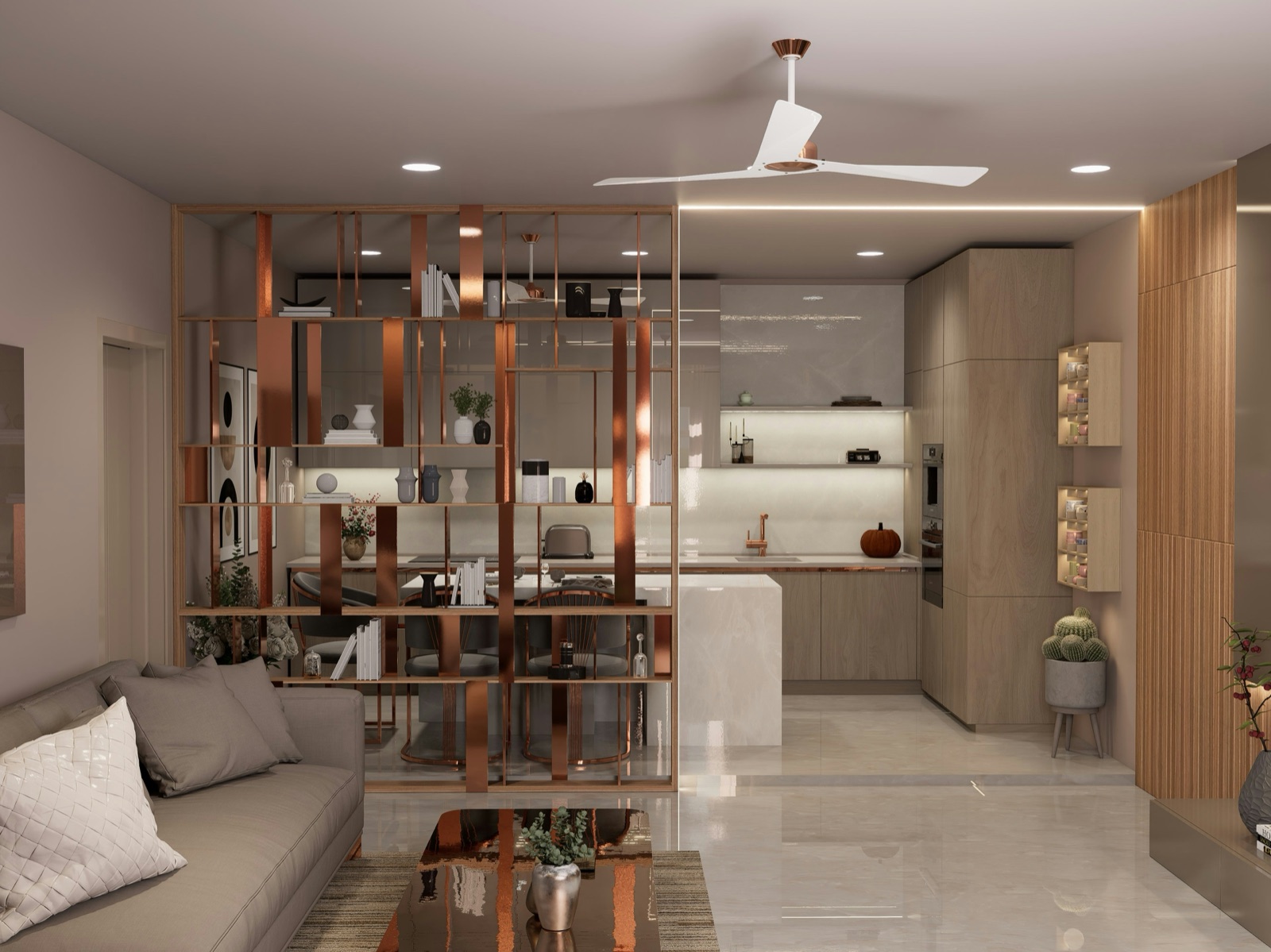 Design render of a 1BHK living room open to its kitchen: a copper-finish open shelf unit separates the grey sofa from a wood-finish kitchen with a white stone island, tall storage and a built-in oven, under a white ceiling fan and recessed lights